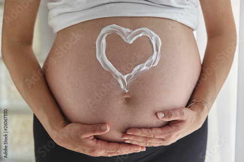 Wallpaper Mural Heart painted with body cream on pregnant woman's belly. Torontodigital.ca