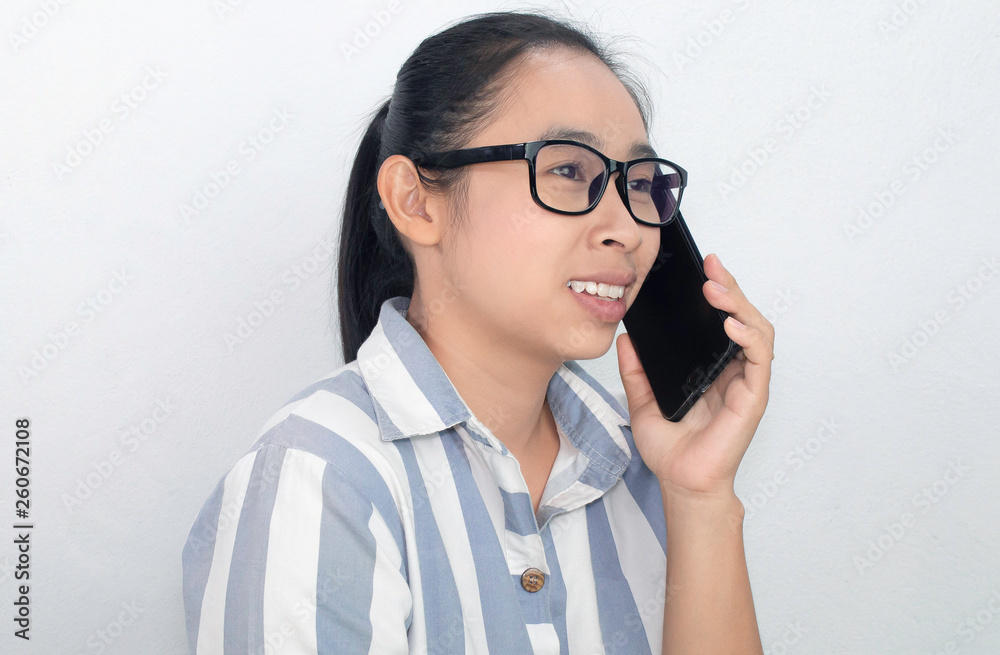 Cheerful Business Asian young woman talking on the phone over white background, Happy and smiling face.