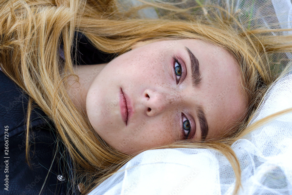Portrait of a beautiful white blonde girl with freckles on her face Portrait of a beautiful white blonde girl with freckles on her face