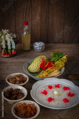 Khao-Chae  Cooked Rice Soaked in Iced Water in the white bowl and Eaten with the Usual Complementary Food and to decorate by flower  scented water.