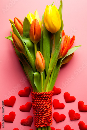 Bouquet of colorful tulips and small red hearts
