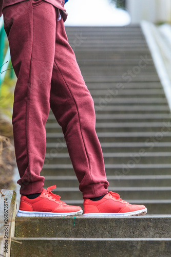 Woman wearing red trainers sportwear shoes