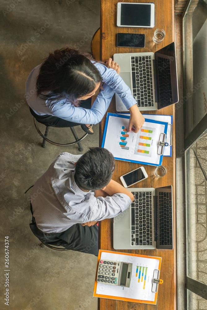 Asian office employee in shirt discuss about work Asian office employee in shirt discuss about work