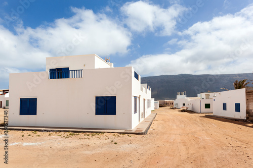 Empty street with sand and white houses in Caleta de Sebo on the island La Graciosa © Peter de Kievith