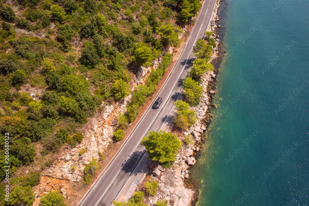 Aerial view of the highway along the rock and water edge, outdoor travel background Aerial view of the highway along the rock and water edge, outdoor travel background