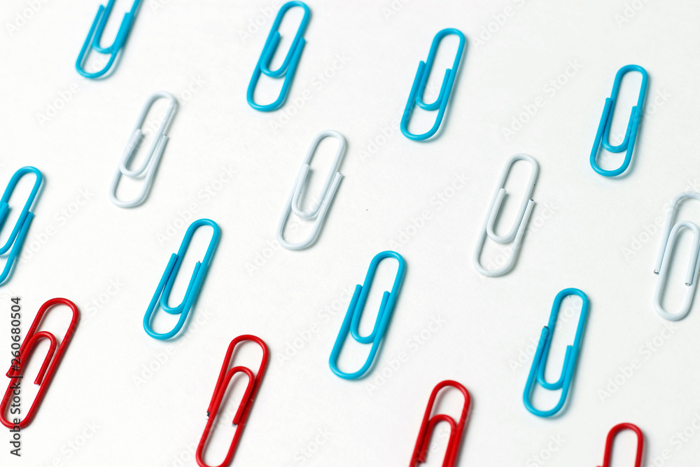 Multicolored paper clips on a white background, office concept Multicolored paper clips on a white background, office concept
