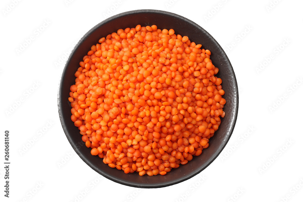 red lentils in black bowl isolated on white background. Top view.
