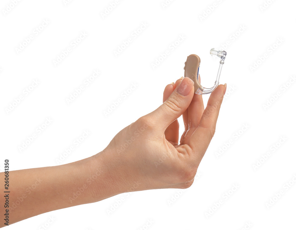Female hand with hearing aid on white background Female hand with hearing aid on white background