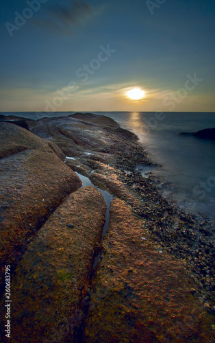 Rock and blue sky with beautiful clouds tropical sea.