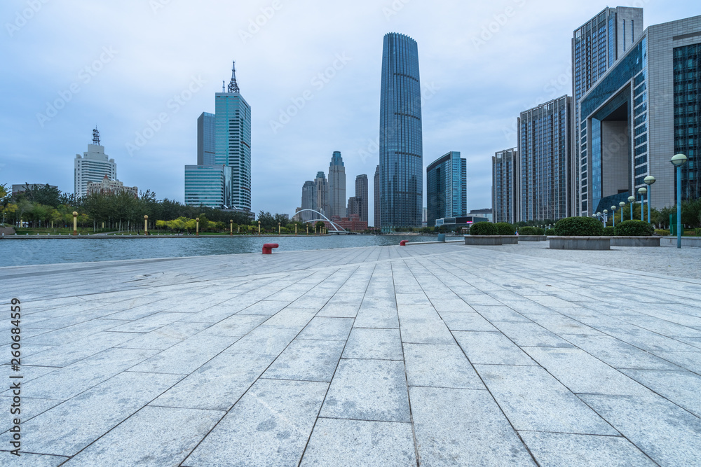 Fototapeta premium empty floor and city skyline under blue sky, tianjin, china.