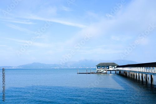 Wallpaper Mural Tropical sand beach island, crystal clear sea water, and docking pier in sunny day. Vacation and holiday in paradise island. Torontodigital.ca