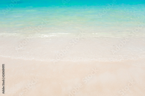 White sand on the beach and beautiful crystal clear turquoise sea water with wave in tropical country Thailand for background use.