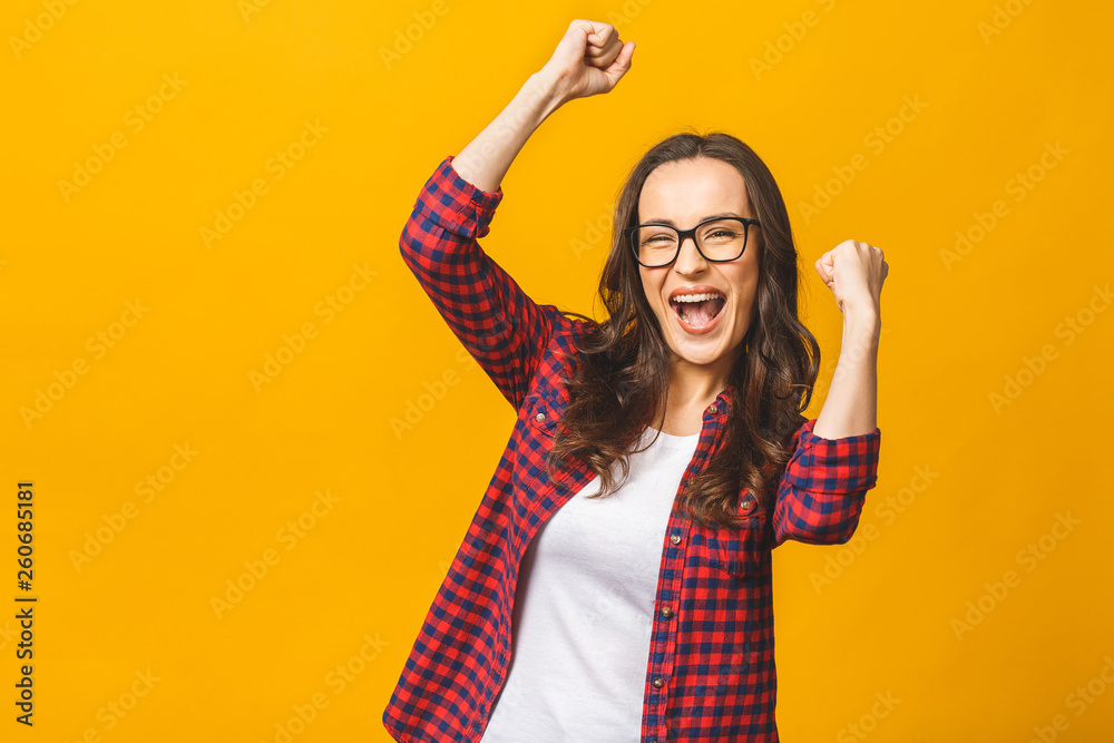 Winning success woman happy ecstatic celebrating being a winner. Dynamic energetic image of multiracial Caucasian Asian female model isolated on yellow background waist up. Winning success woman happy ecstatic celebrating being a winner. Dynamic energetic image of multiracial Caucasian Asian female model isolated on yellow background waist up.