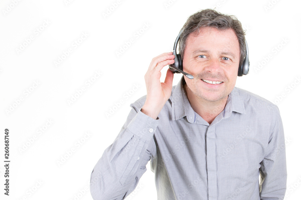 handsome young man in work in call-centre with headphones on white background with copy space handsome young man in work in call-centre with headphones on white background with copy space