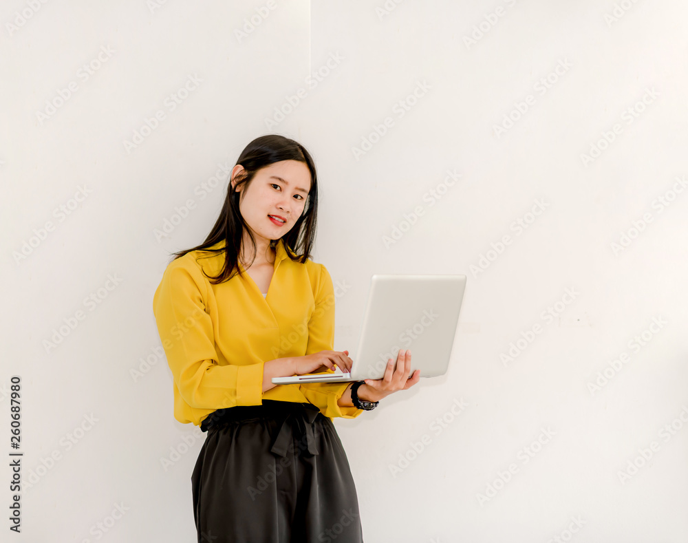 Smile Asian girl holding a laptop computer separately on a white background. Smile Asian girl holding a laptop computer separately on a white background.