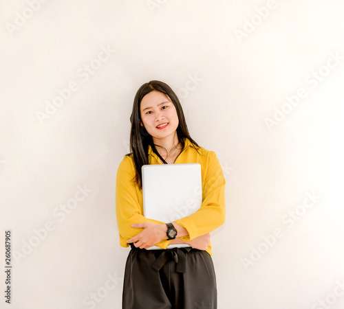 Smile Asian girl holding a laptop computer separately on a white background.