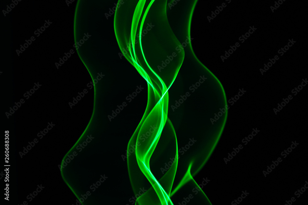 Neon green smoke abstract.  Isolated on black background.
