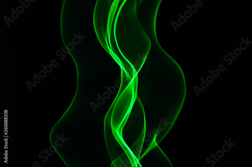 Neon green smoke abstract. Isolated on black background.