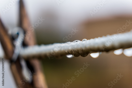 Raindrops on a clothes line isolated with a blurred background 