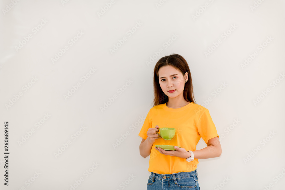 The image of a beautiful Asian woman smiling brightly while drinking coffee on a white background. The image of a beautiful Asian woman smiling brightly while drinking coffee on a white background.