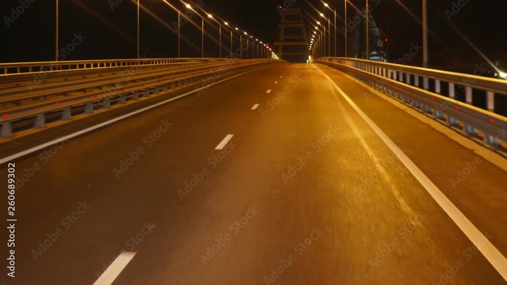 Vehicle PoV road driving at night across the Kerch Strait Bridge. Crimean Bridge four-lane highway linking Crimea with Russia. Vehicle PoV road driving at night across the Kerch Strait Bridge. Crimean Bridge four-lane highway linking Crimea with Russia.