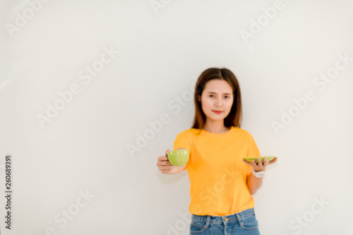 Asian girl is drinking coffee on a white background