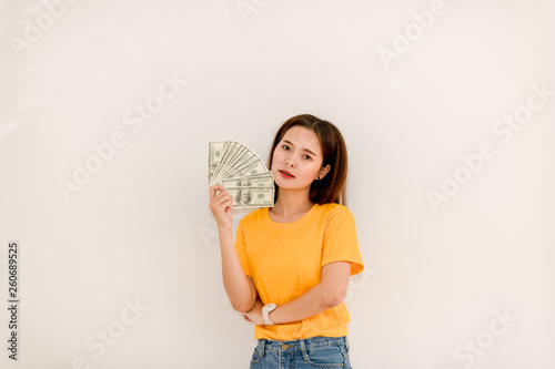 Asian girls are holding a dollar on a white background