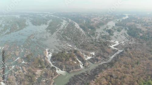 Aerial: flying over Don Det and the 4000 islands Mekong River in Laos, Li Phi waterfall, famous tourist destination in South East Asia, stunning landscape. Native cinelike D-log color profile photo