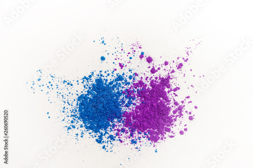 Bright eye shadows in different blue tones, scattered on a white background.