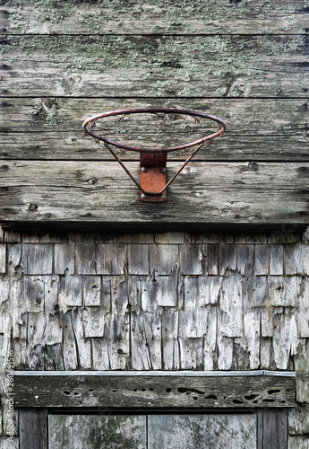 An neglecyed basketball hoop mounted on a old barn, Massachusetts, USA. photo