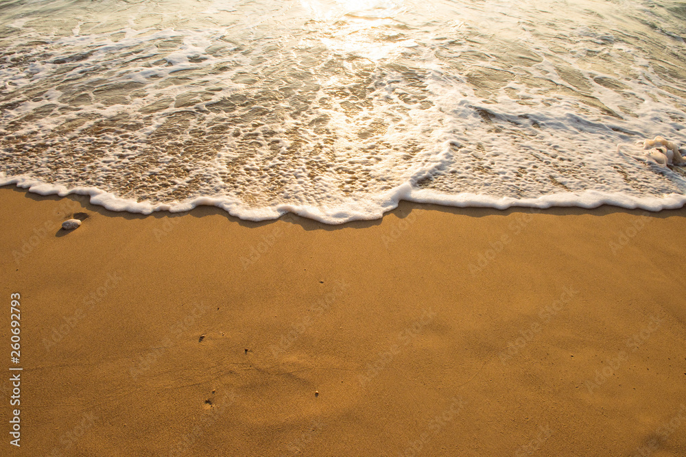 Soft wave of blue ocean on sandy beach. Background. - obrazy, fototapety, plakaty 