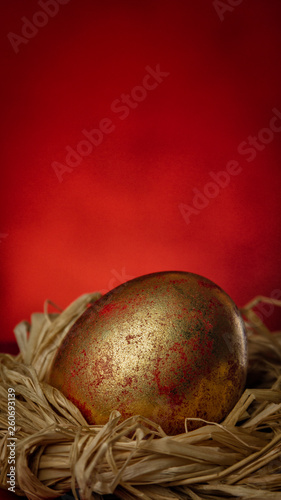 Success Easter Concept Golden Egg on Bright Red Background