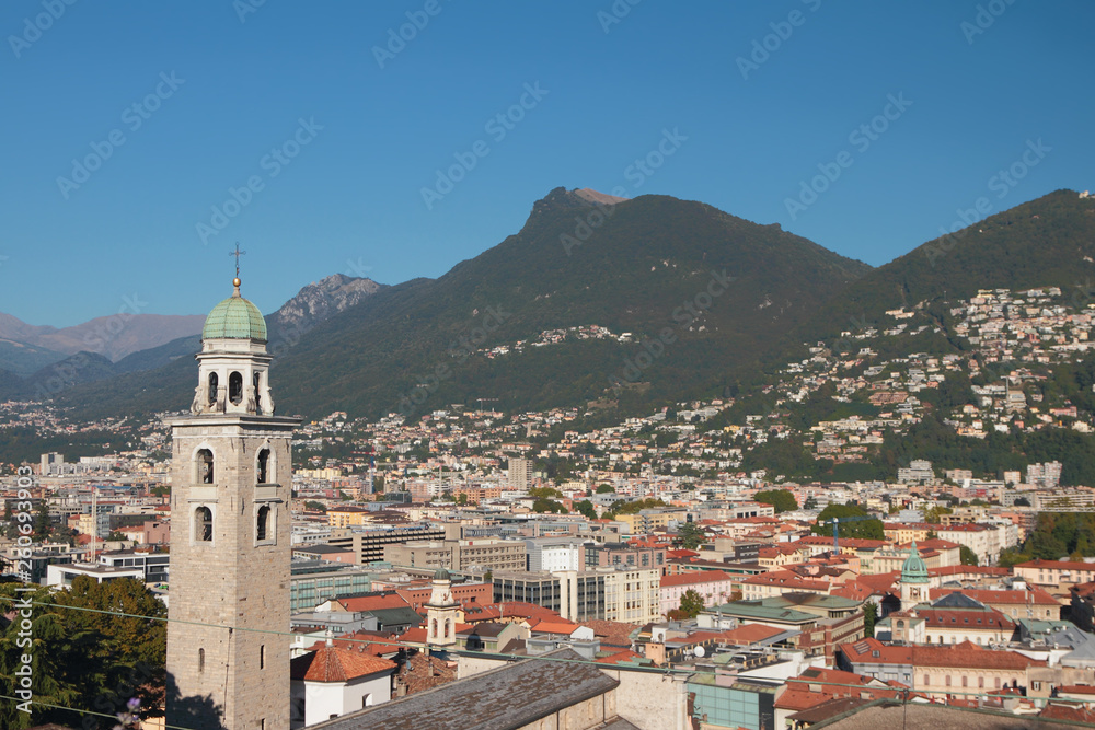 Bell tower, city and foothills of Alps. Lugano, Switzerland