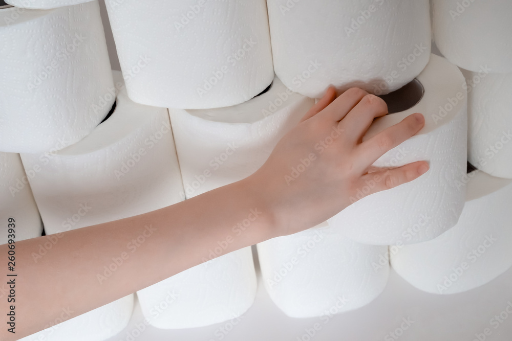 the child's hand takes out of the pile of toilet paper.