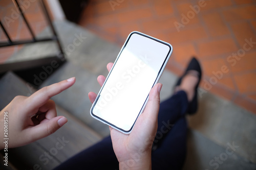 Asian girls holding sale shopping bags. consumerism lifestyle concept in the shopping mall hands holding cell telephone blank copy space screen.