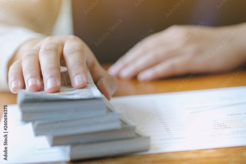Businessman analyzing investment charts and pressing calculator buttons over documents. Accounting Concept. Businessman analyzing investment charts and pressing calculator buttons over documents. Accounting Concept.
