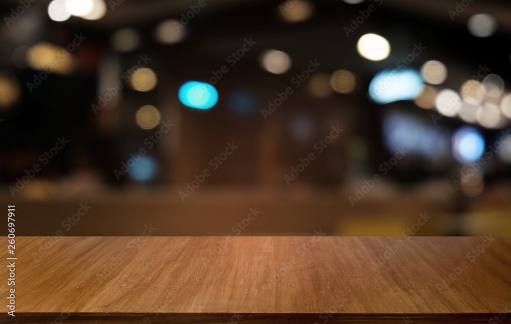 Empty dark wooden table in front of abstract blurred bokeh background of restaurant . can be used for display or montage your products.Mock up for space.