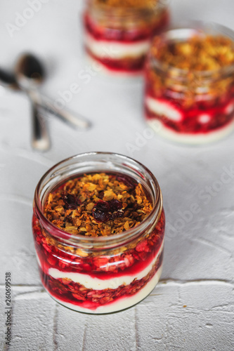 Berry crumble dessert with cream sauce in small jars