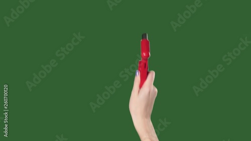 Chromakey. Green screen. Woman hand with red hammer breaks glass.
