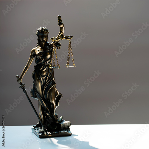 Statue of blind goddess Themis on blurred background