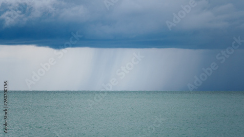 Seascape with rain in the distance