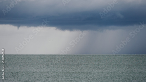 Seascape with rain in the distance