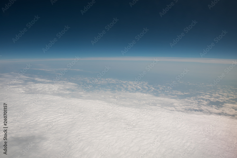 View from the airplane. Flight over the clouds