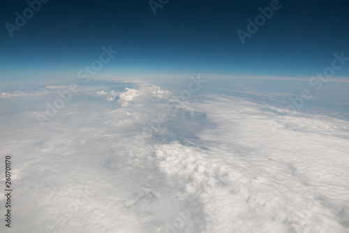 View from the airplane. Flight over the clouds