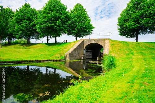 brick sluice, bridge across canal in park Klundert, The Netherlands 