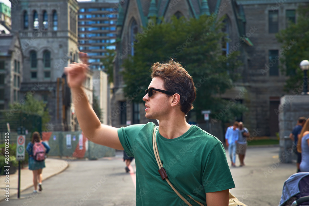 Montreal, Quebec, Canada, September 01, 2018: Portrait of a young guy in sunglasses near the McGill Campus - Redpath Museum, Sherbrooke West Street, Montreal, Canada Travel