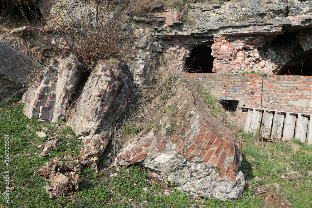 Fototapeta premium ruins of a blown up fortress with a sign with a destroyed walls