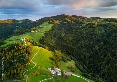 Aerial shot of green hills of Slovenia at sunrise