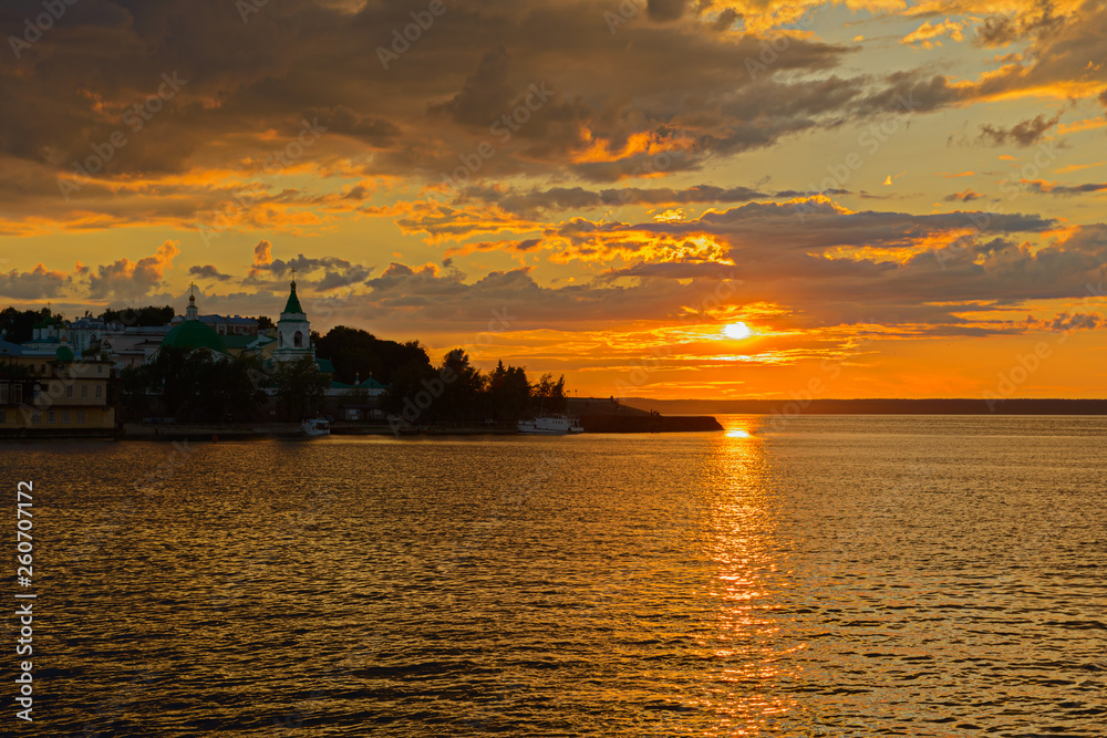 Naklejka premium July 5, 2014: Sunset sun on the embankment of the Volga River near the city of Cheboksary. Cheboksary. Russia.