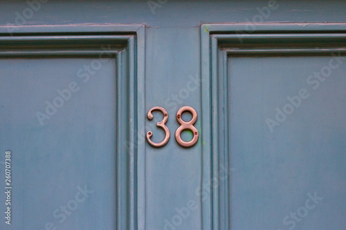 Elegantly framed house number 38 with the thirty eight centered on the wooden house door photo